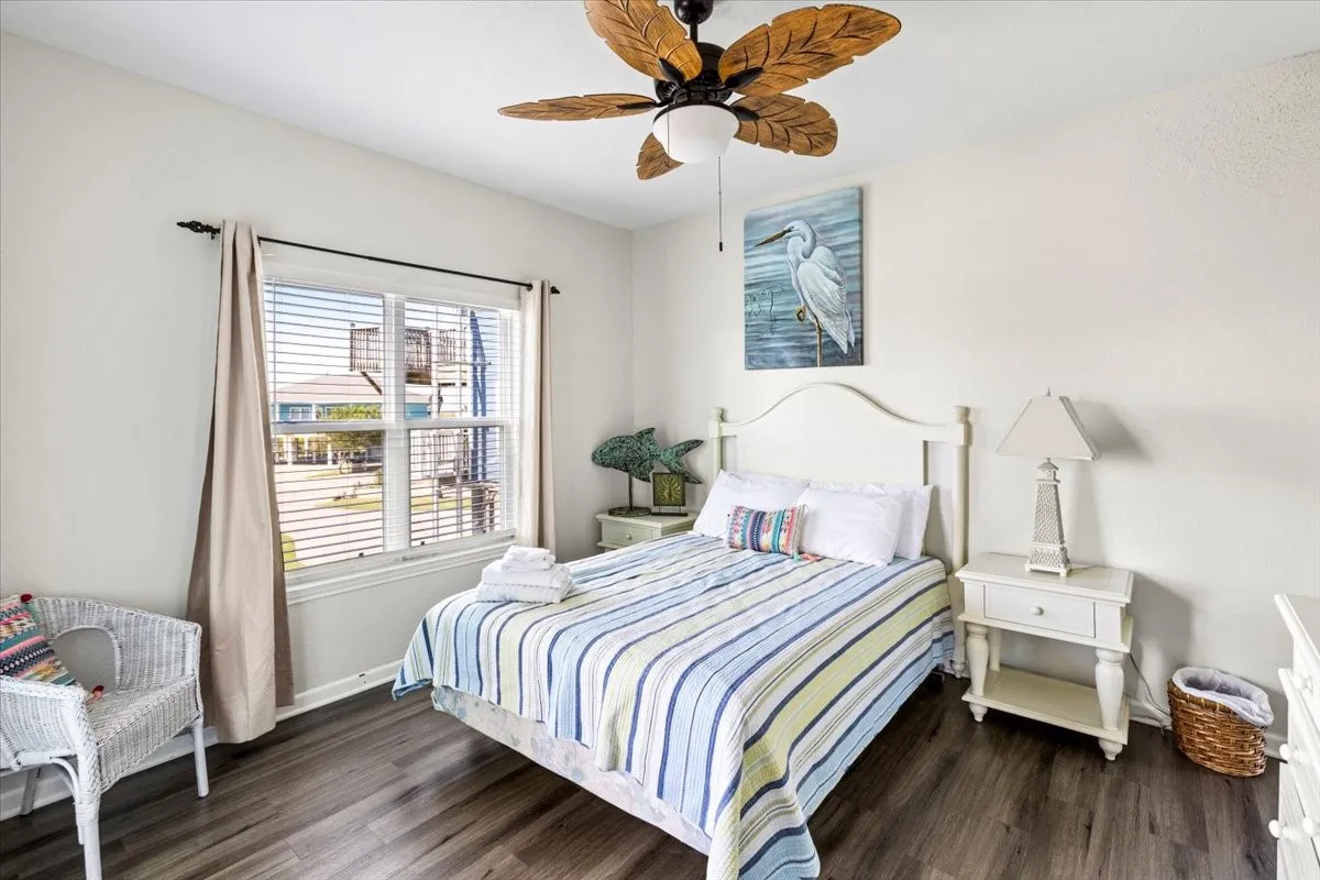 Bedroom featuring ceiling fan and dark wood-type flooring