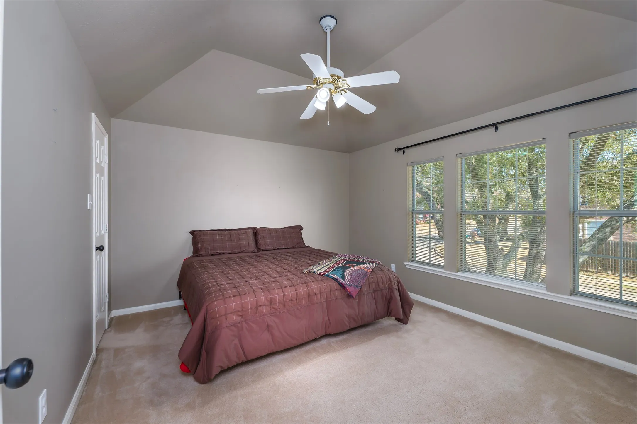 Bedroom featuring lofted ceiling, carpet floors, and a ceiling fan