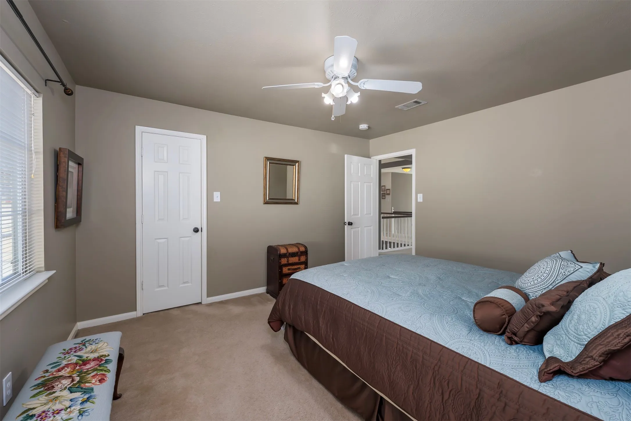Bedroom with light carpet and ceiling fan