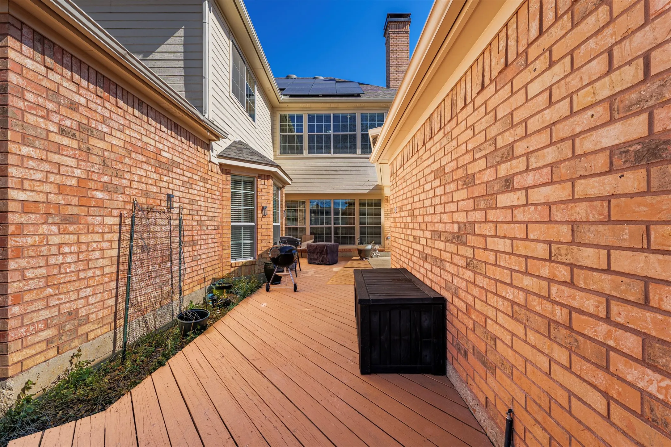 Wooden deck featuring area for grilling