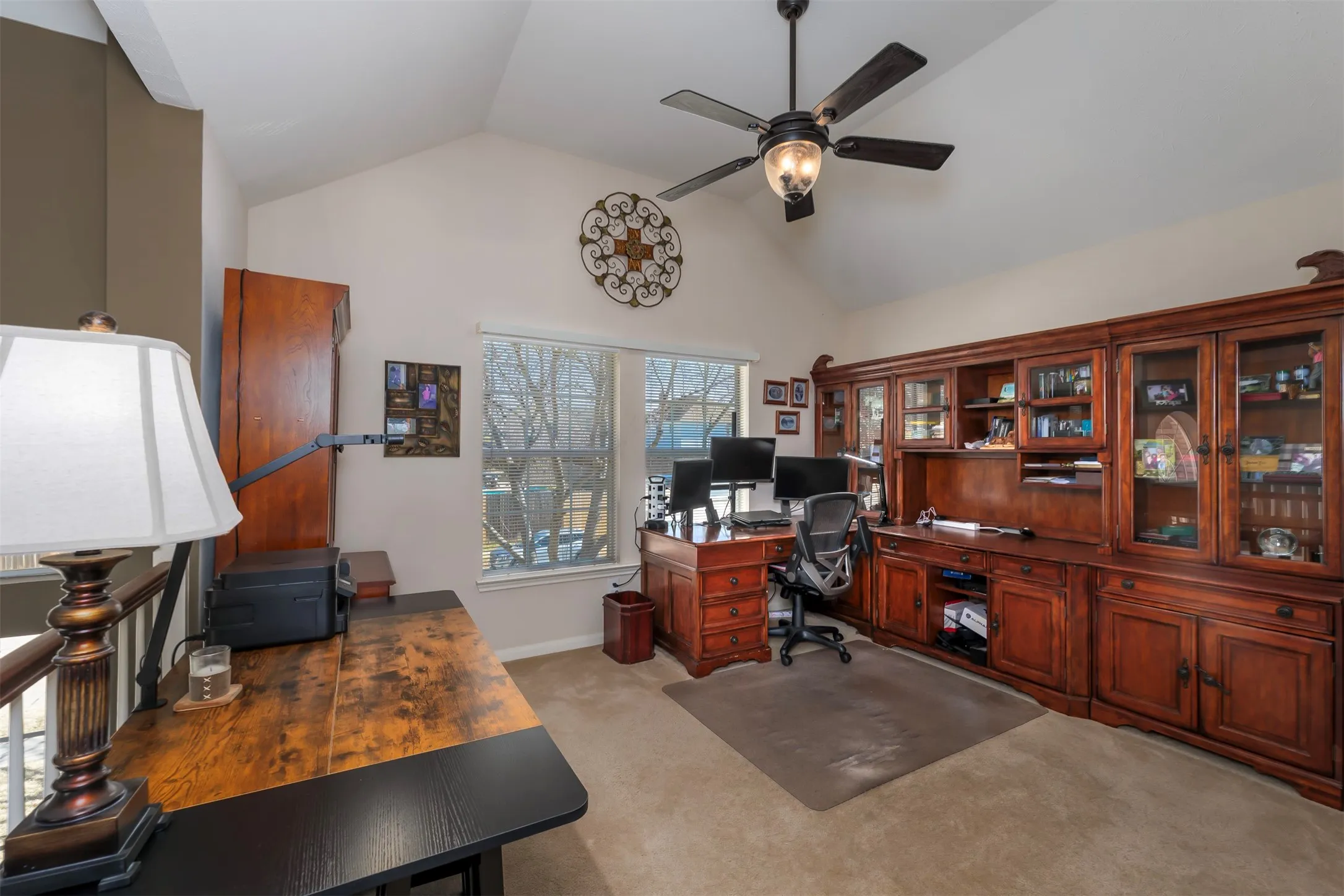 Office area featuring light carpet and ceiling fan