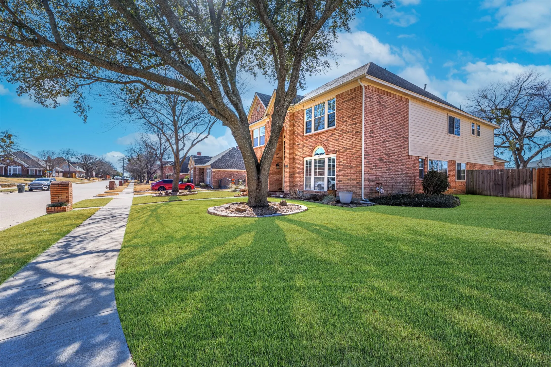 View of property exterior with brick siding and a residential view