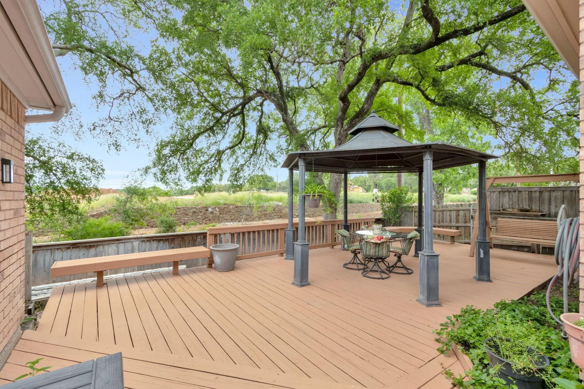 Deck featuring a gazebo and outdoor dining area