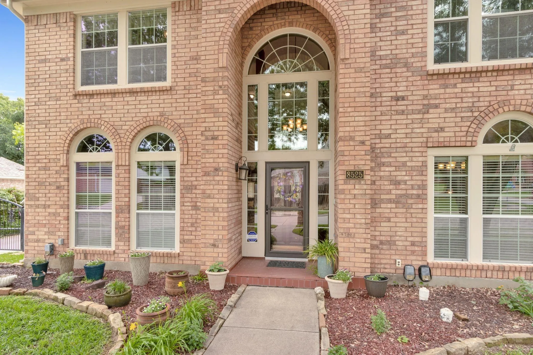 View of exterior entry featuring brick siding