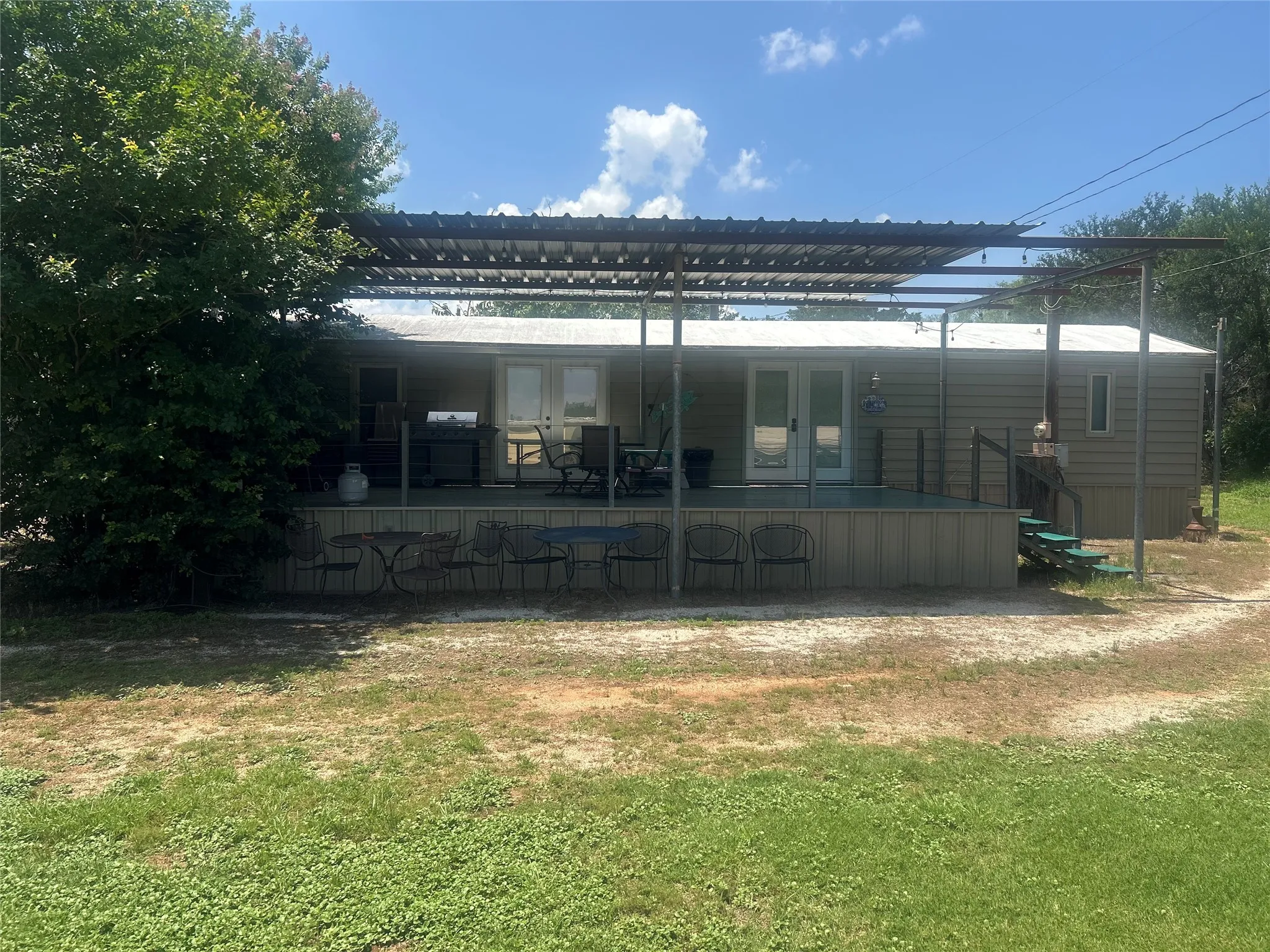 Back of property with french doors and a yard