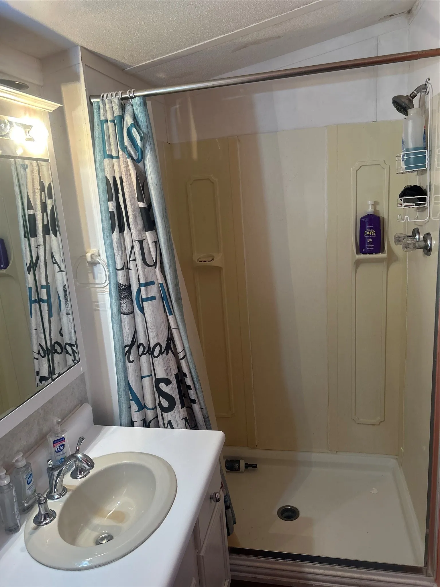 Full bath with a shower stall and vanity