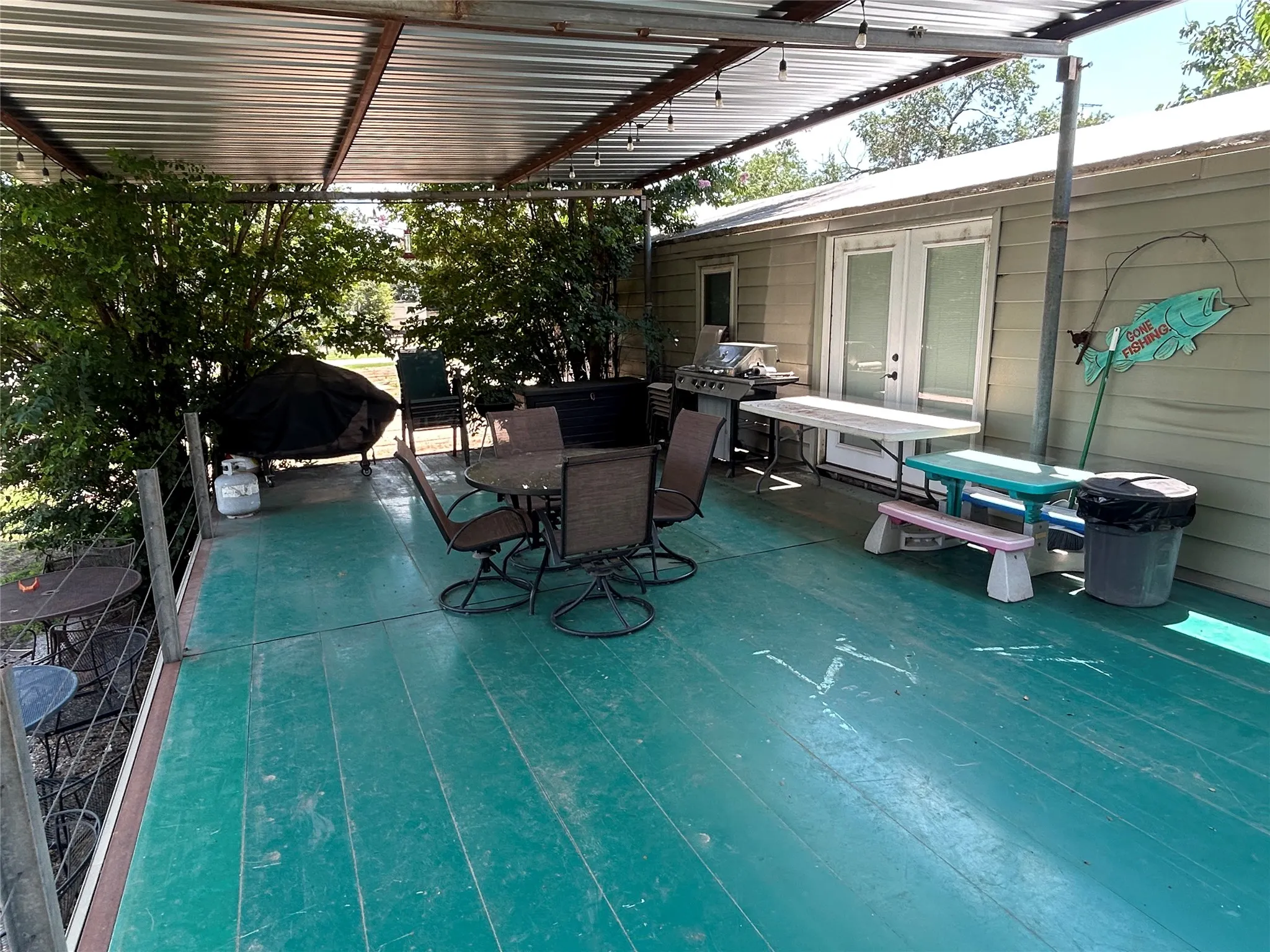 View of patio / terrace with outdoor dining space, french doors, a deck, and area for grilling