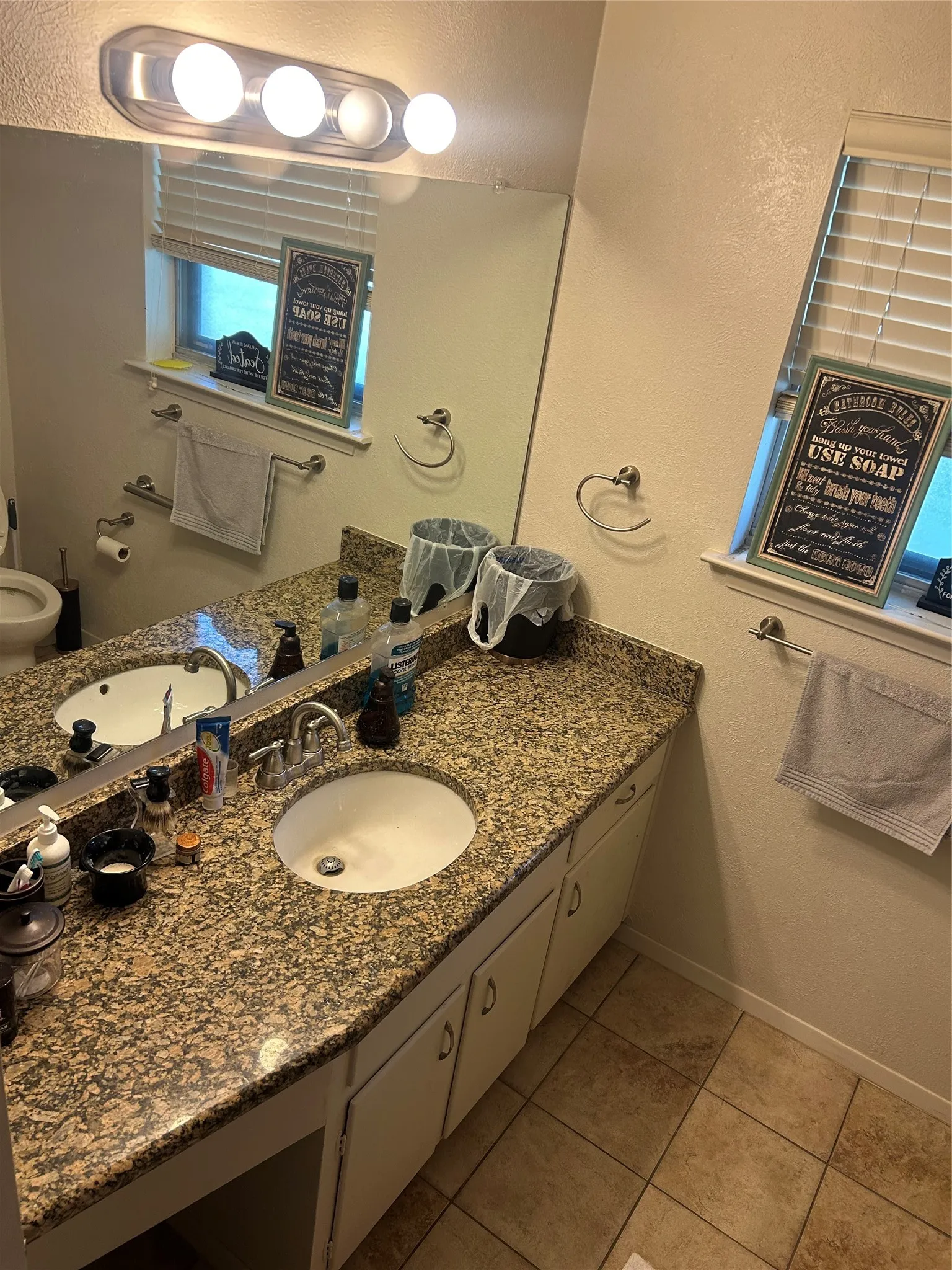 Bathroom featuring tile patterned flooring, vanity, and baseboards