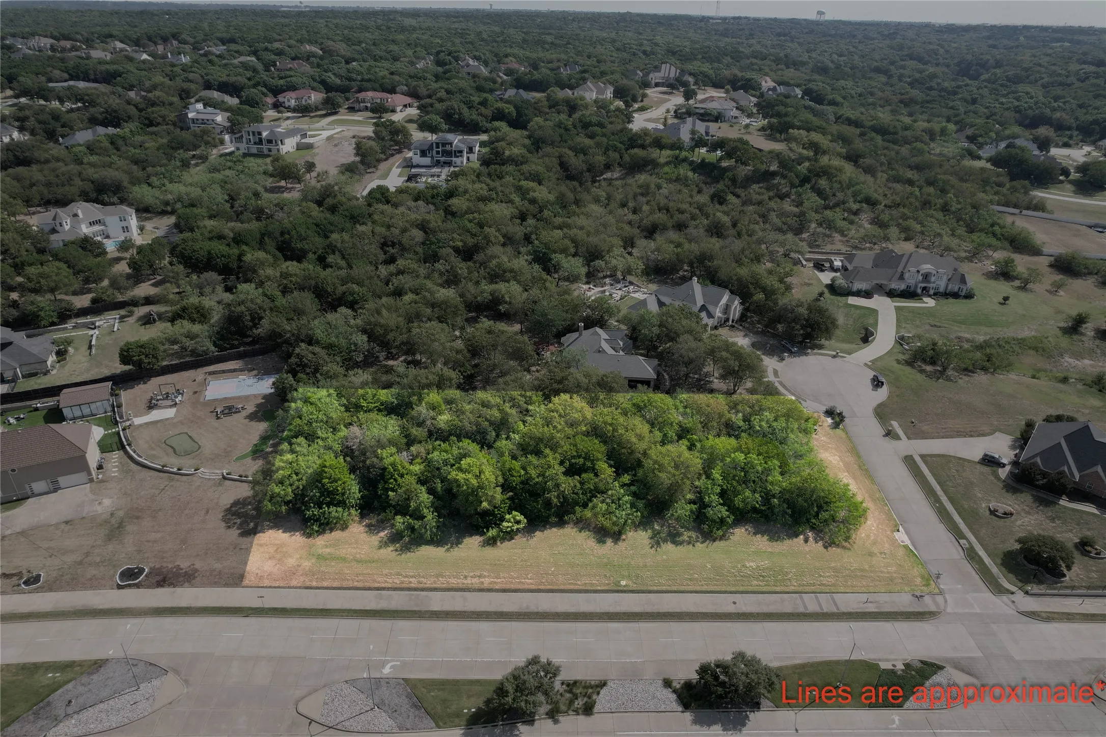 Aerial view of residential area with a heavily wooded area