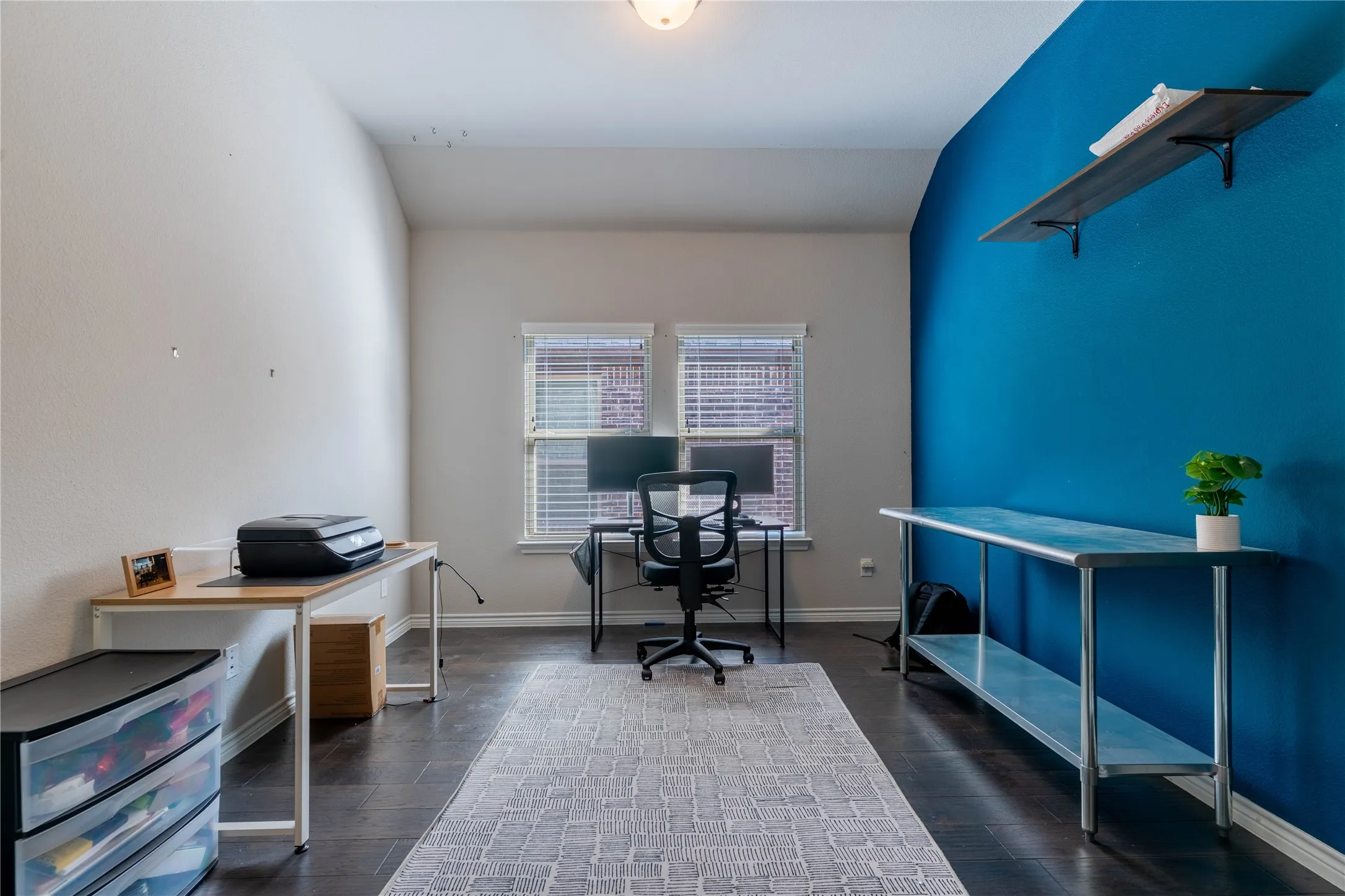 Office with baseboards and dark wood-type flooring