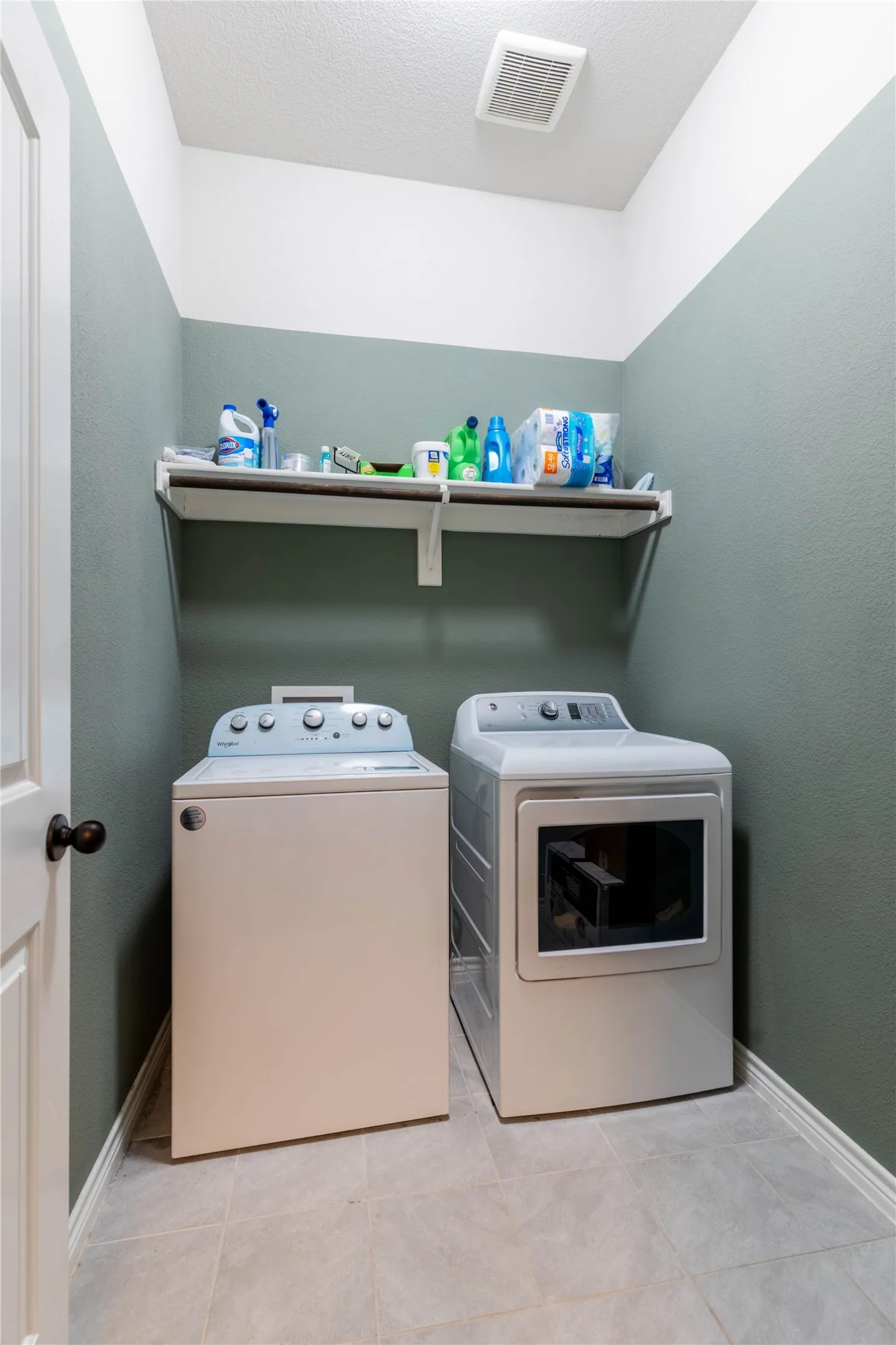 Laundry area featuring baseboards and washer and dryer