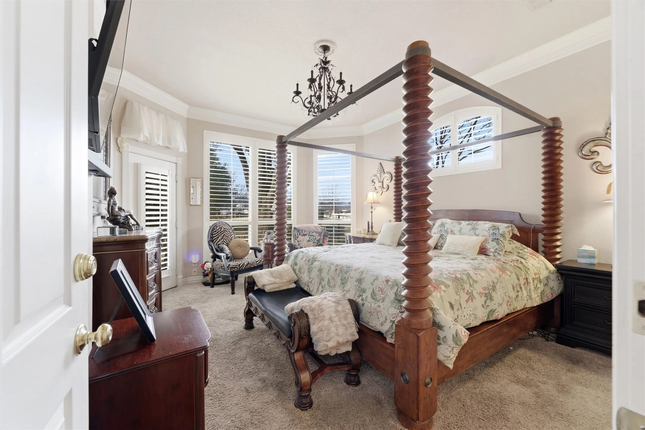 Bedroom with light carpet and ornamental molding