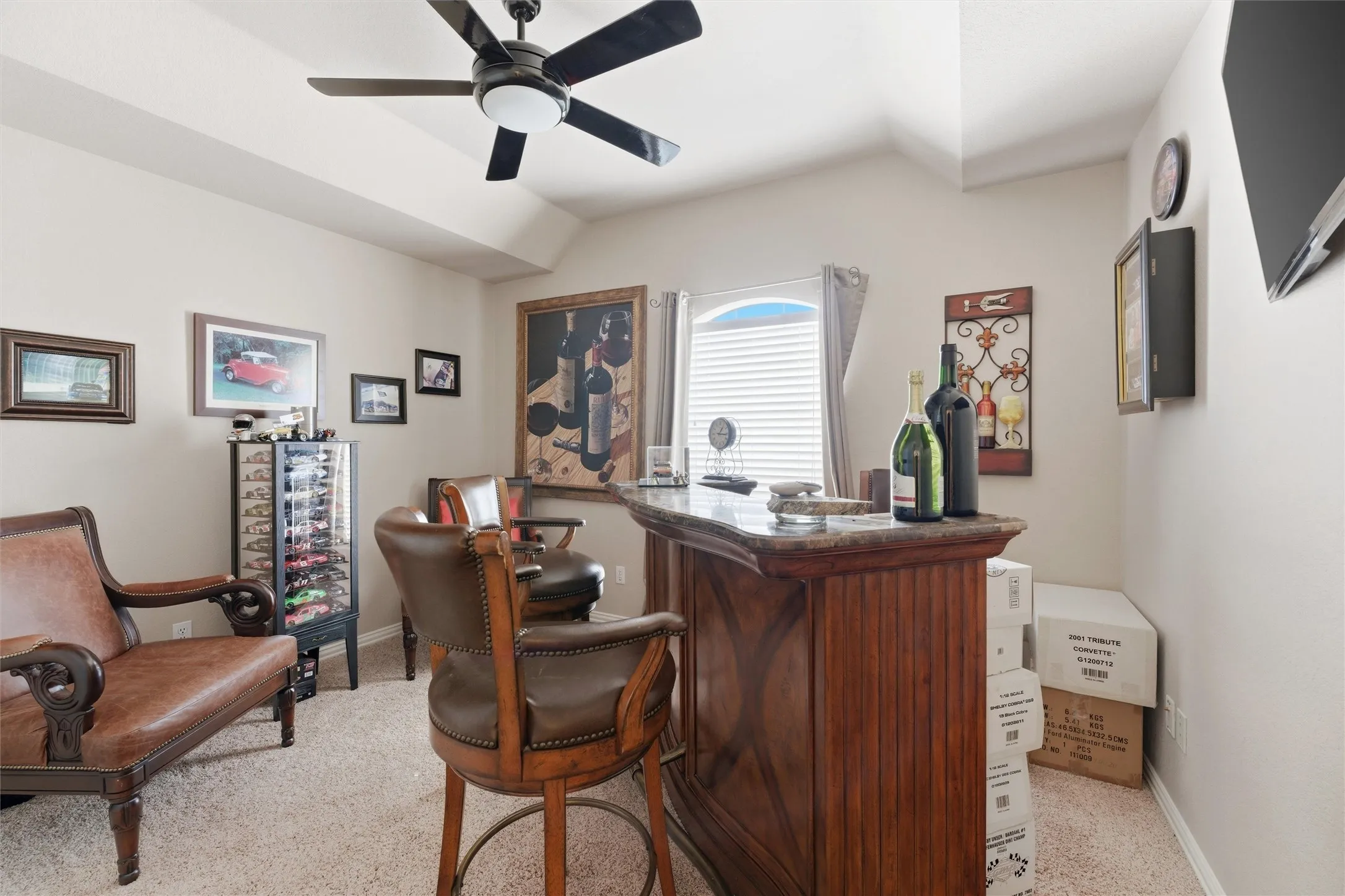 Office space with a dry bar, lofted ceiling, and ceiling fan