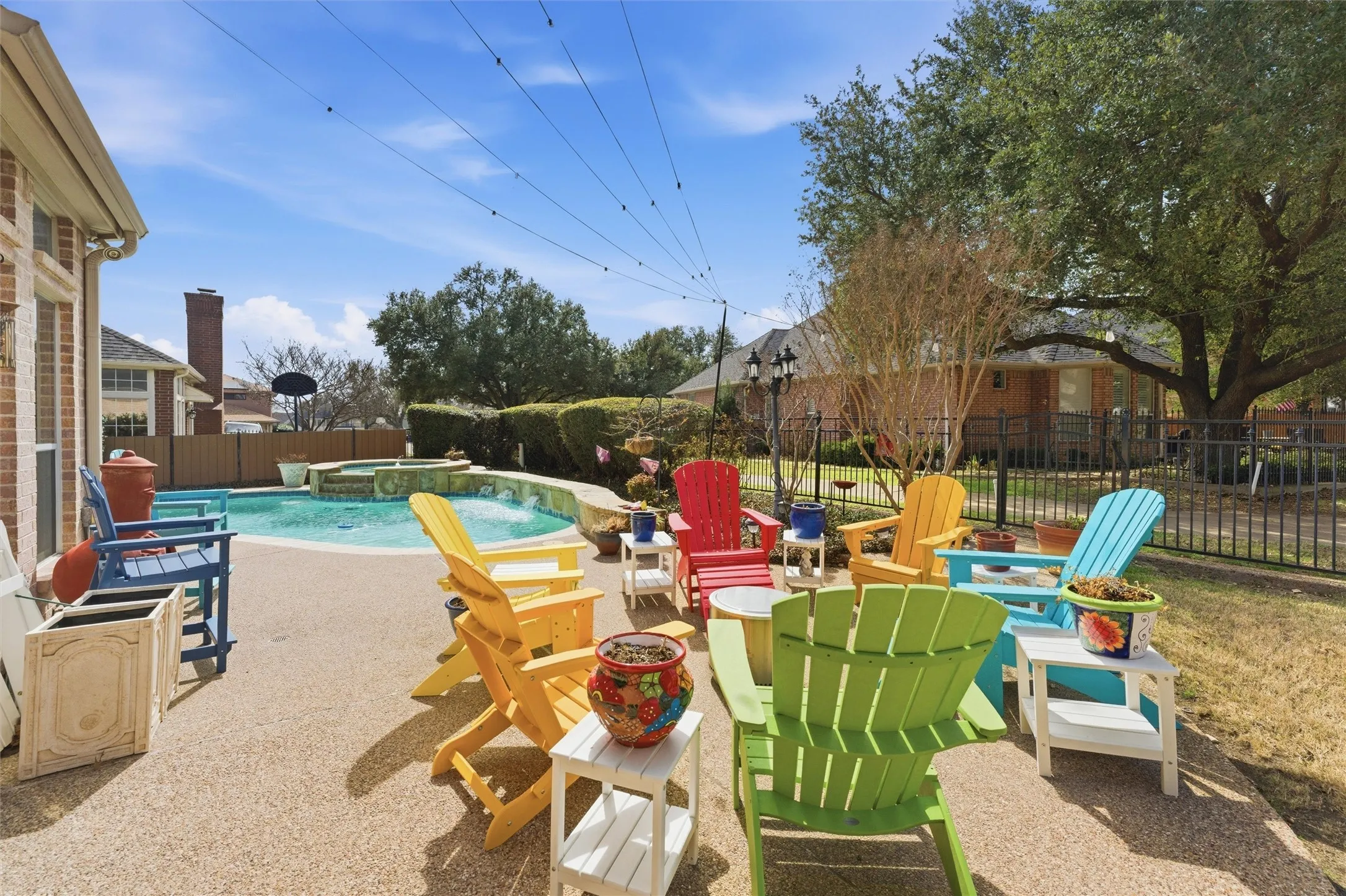 Integrated pool / hot tub featuring a patio and a fenced backyard
