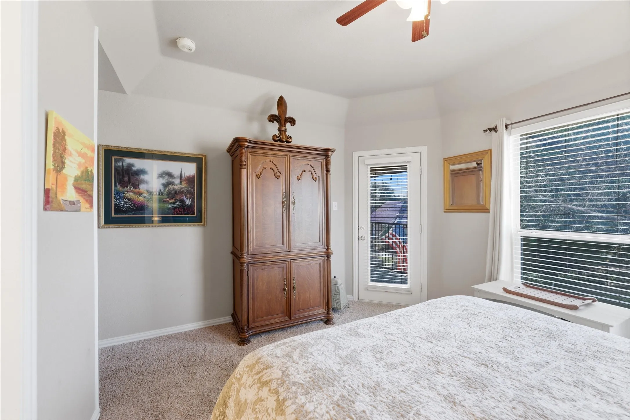 Bedroom featuring access to outside, light colored carpet, and a ceiling fan