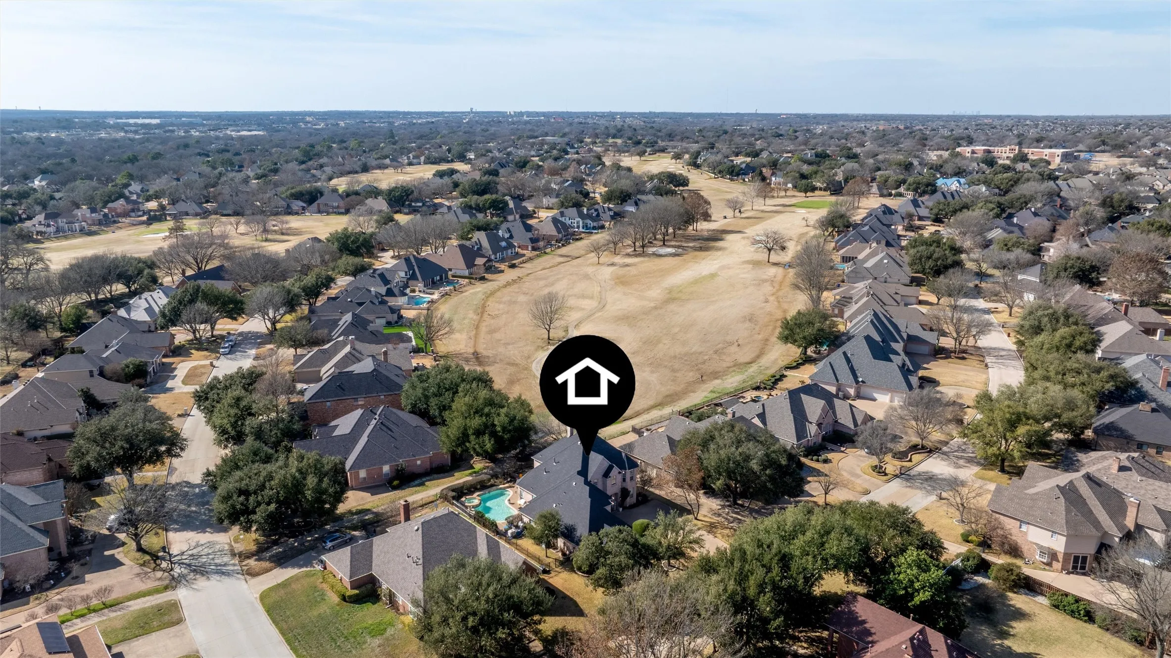 Aerial view of property and surrounding area featuring nearby suburban area