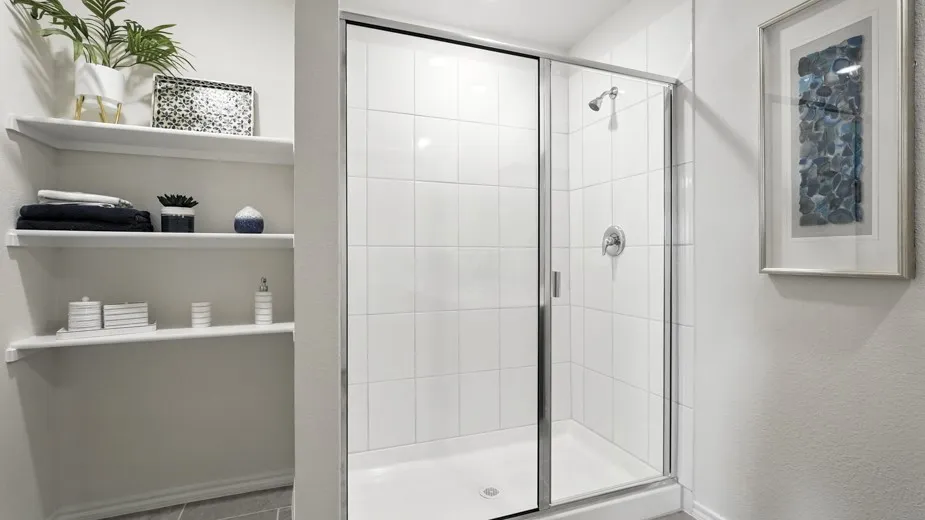 Full bath featuring a stall shower and baseboards