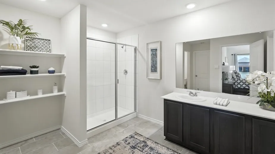 Ensuite bathroom with a stall shower and vanity