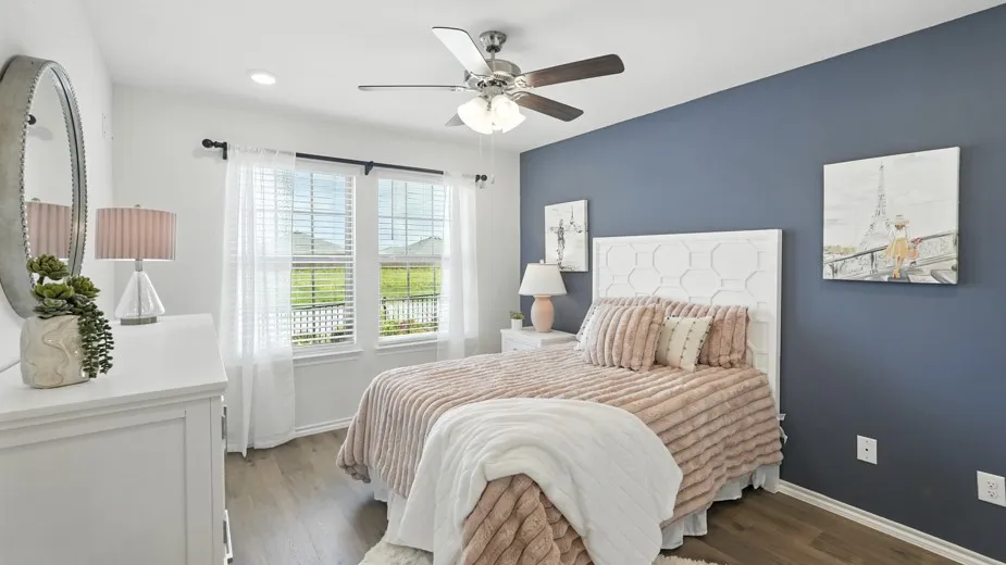 Bedroom with dark wood-type flooring and a ceiling fan