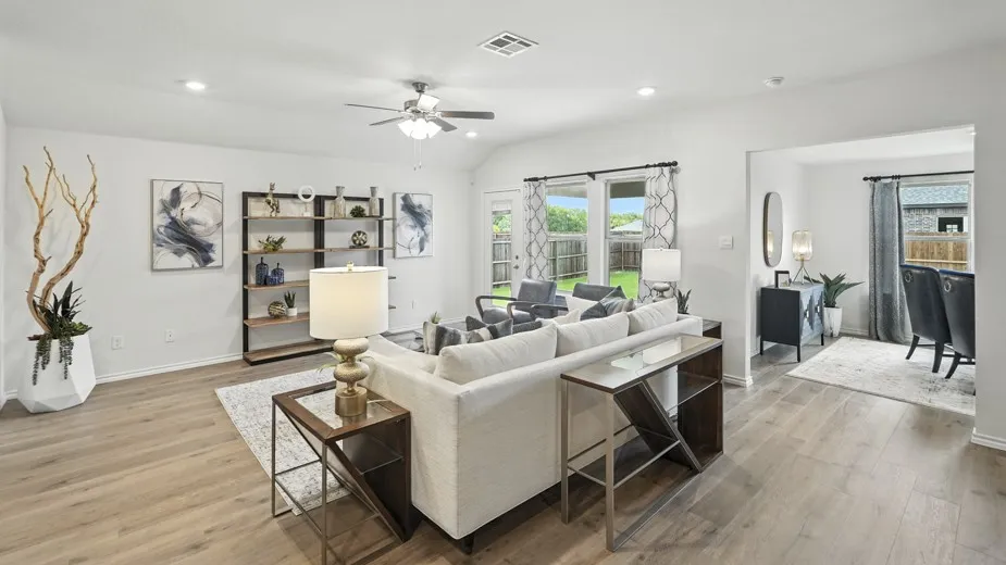 Living room featuring light wood-style flooring, vaulted ceiling, a ceiling fan, and recessed lighting