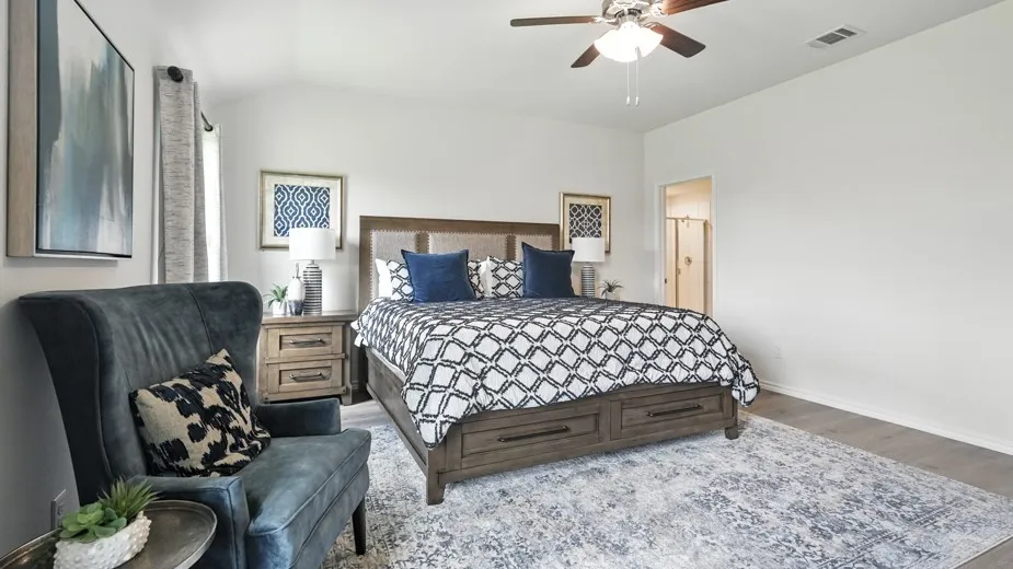 Bedroom with wood finished floors, ceiling fan, and vaulted ceiling