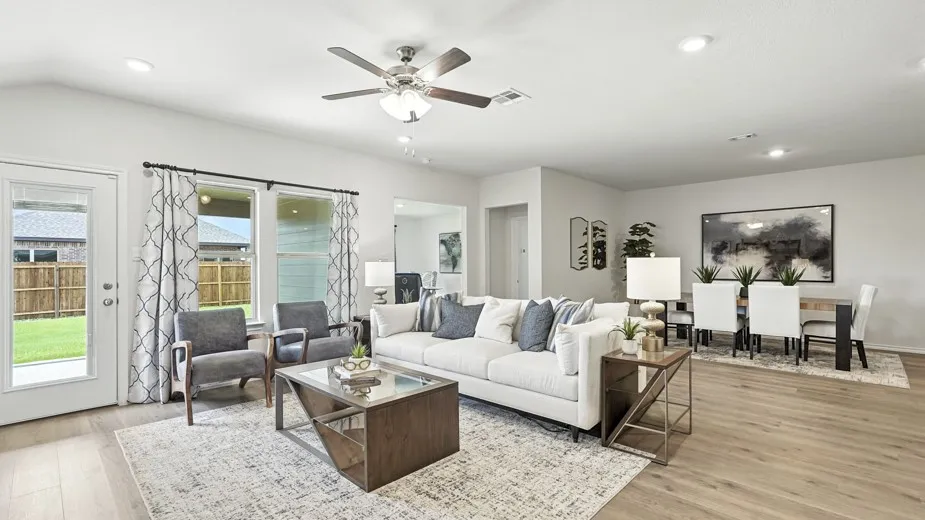 Living room featuring light wood-style flooring, a ceiling fan, and recessed lighting