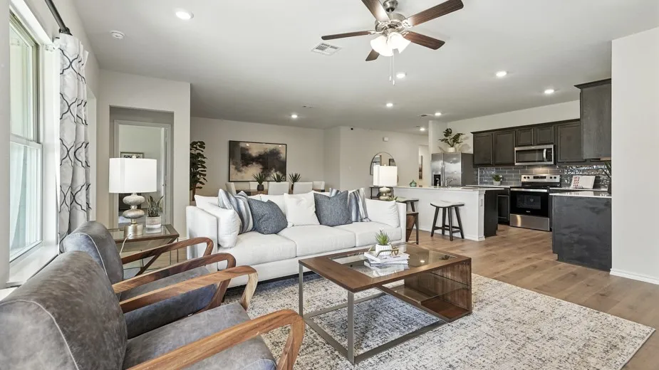 Living area with a ceiling fan, light wood-style floors, and recessed lighting