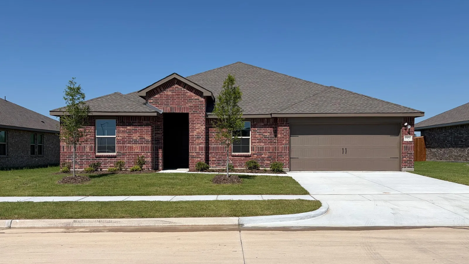 Red brick exterior with a dark brown shingle roof