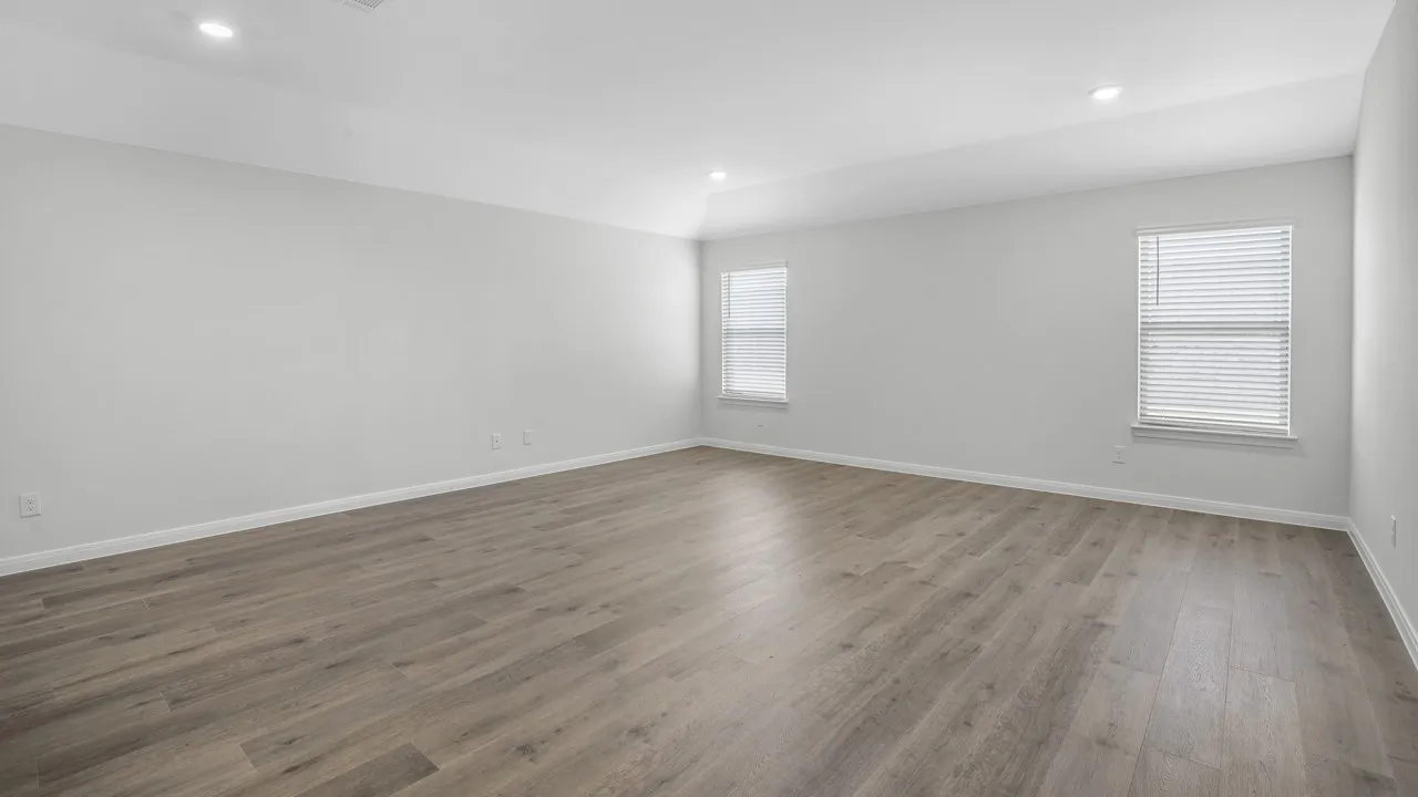 Unfurnished room featuring plenty of natural light, dark wood-type flooring, and recessed lighting