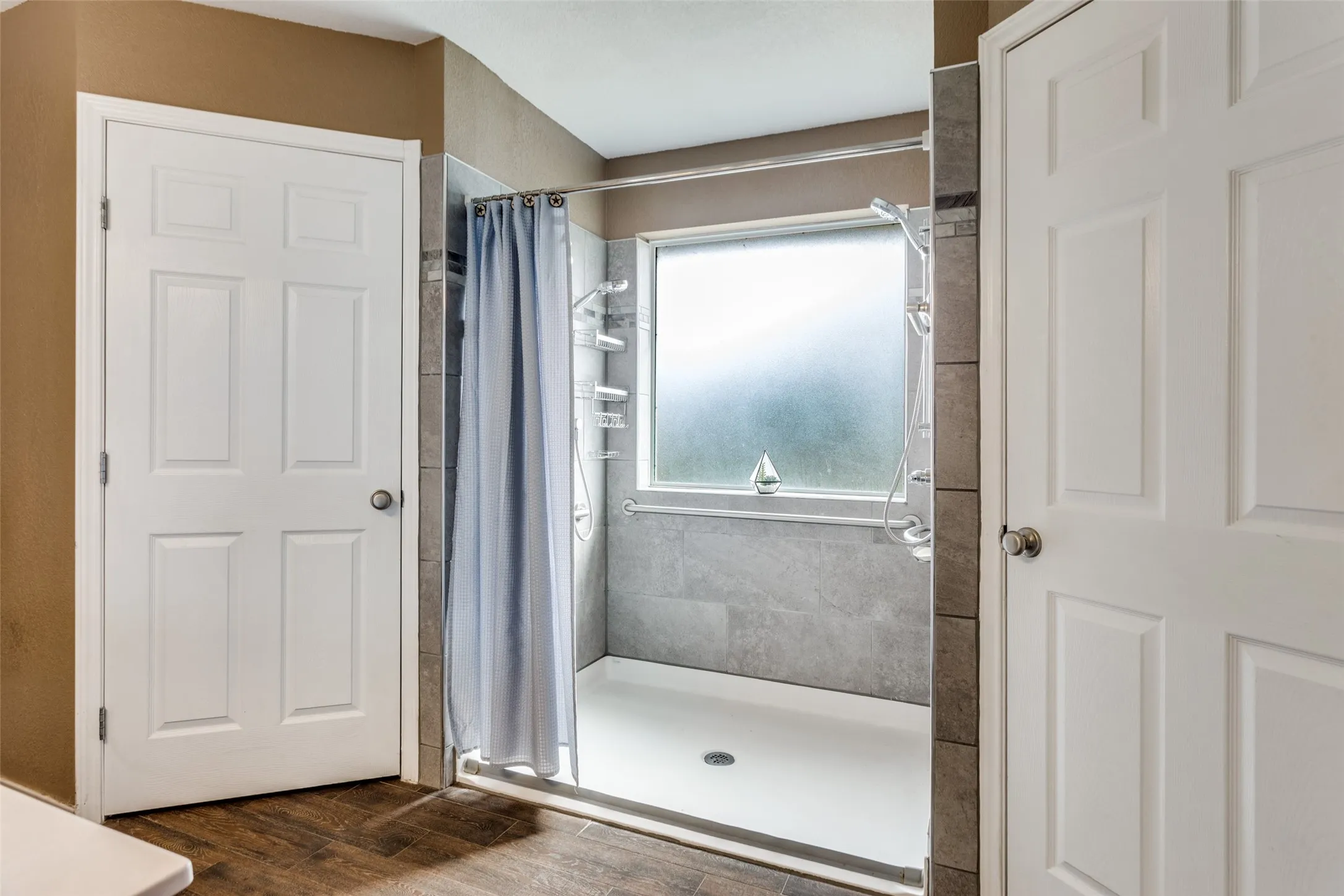 Walk in or roll in bathroom with twin shower heads.