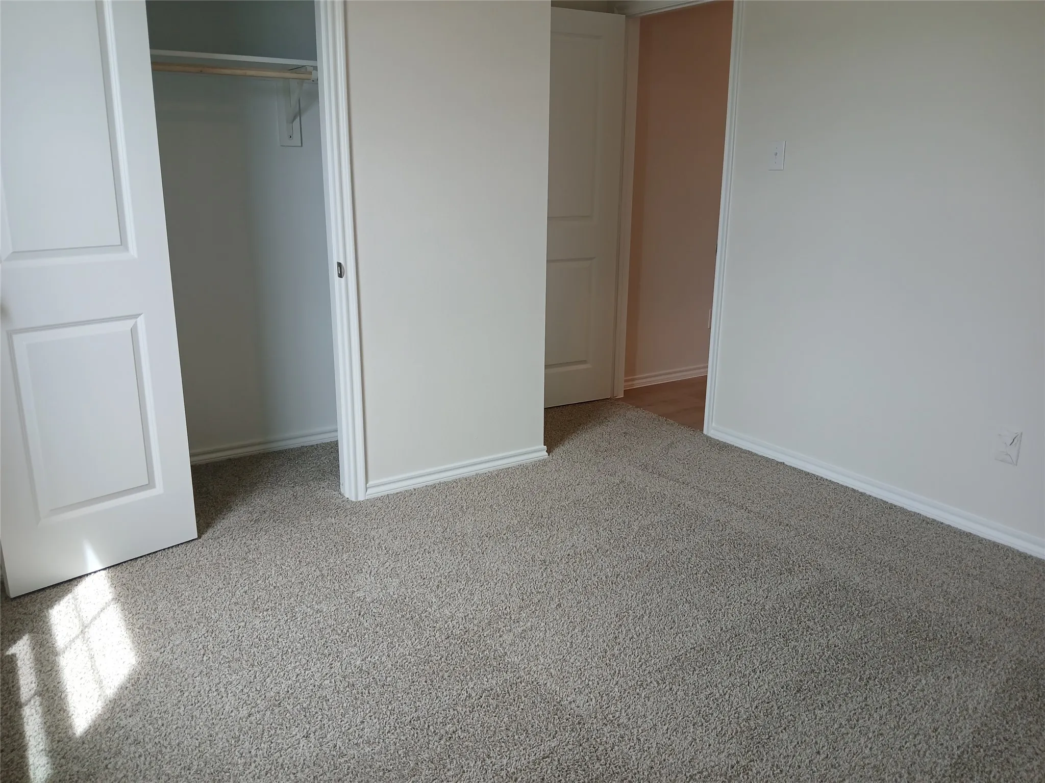 Light neutral-toned carpeting throughout the space