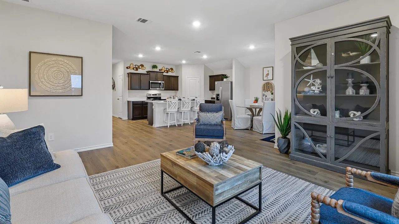 Spacious living area featuring wood-finish flooring, recessed lighting, and a neutral color palette