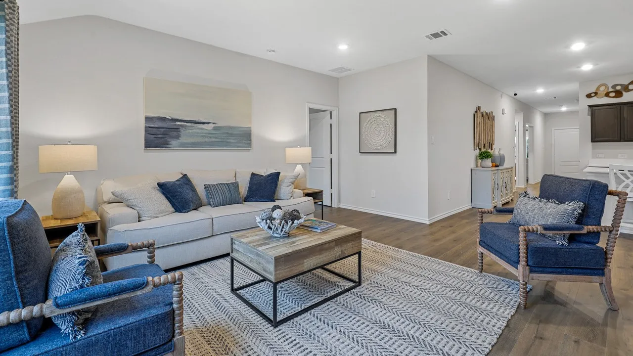 Spacious living area featuring wood-finish flooring, recessed lighting, and a neutral color palette