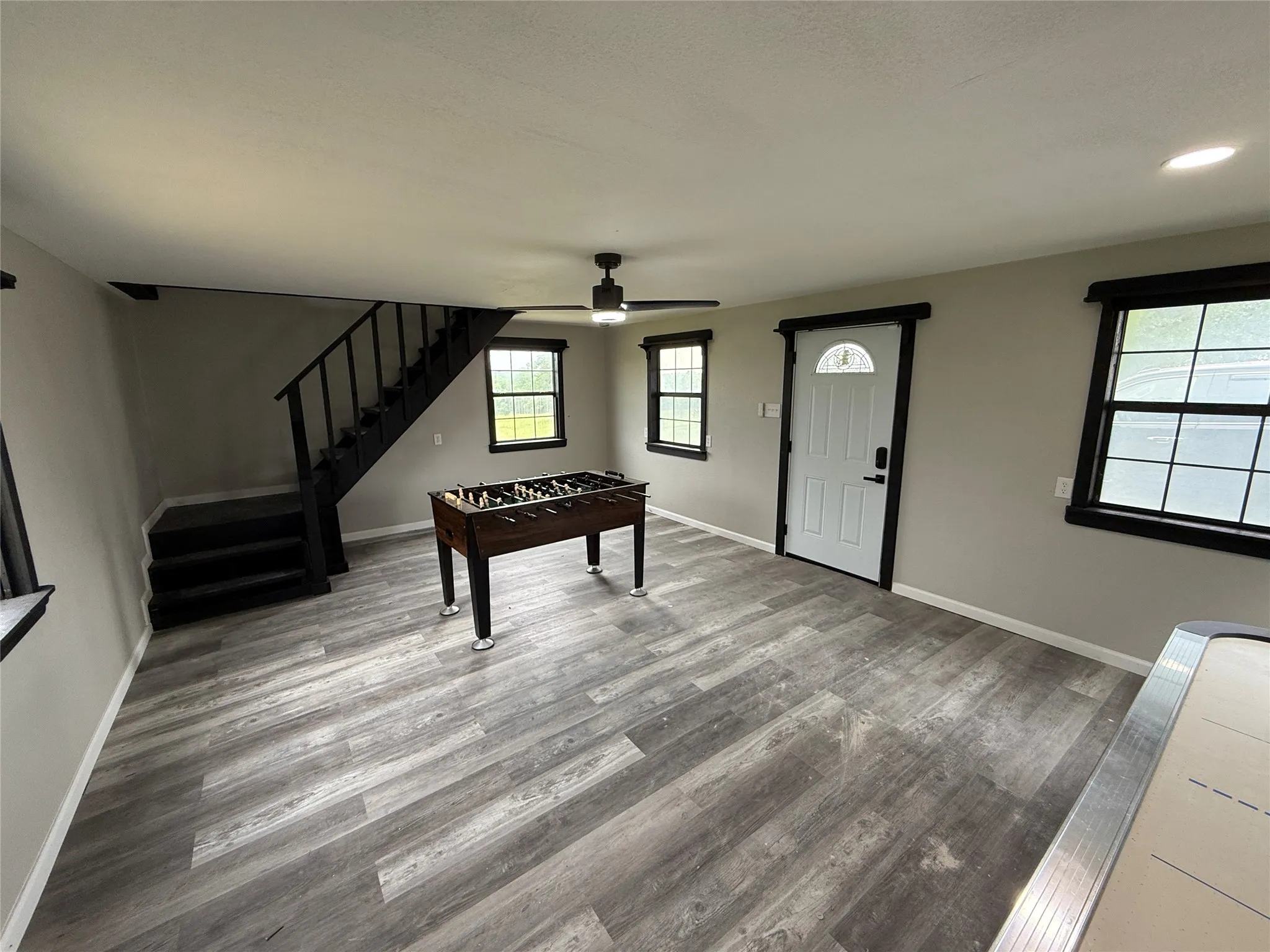 Playroom with wood finished floors and ceiling fan
