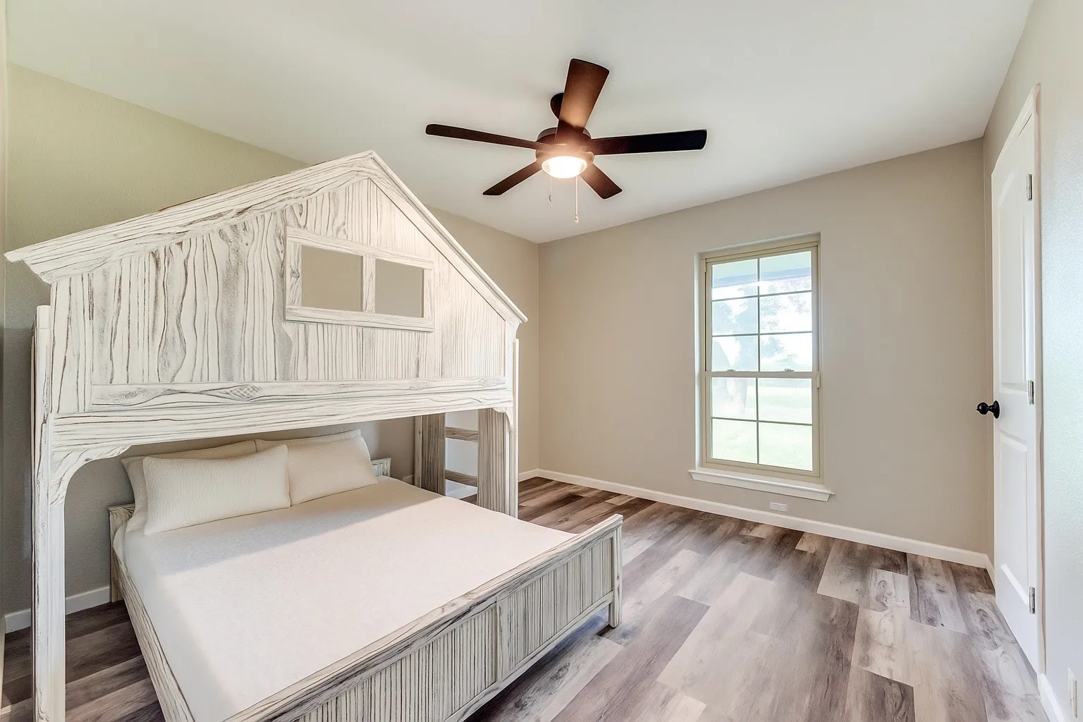 Bedroom with light wood-style floors and ceiling fan