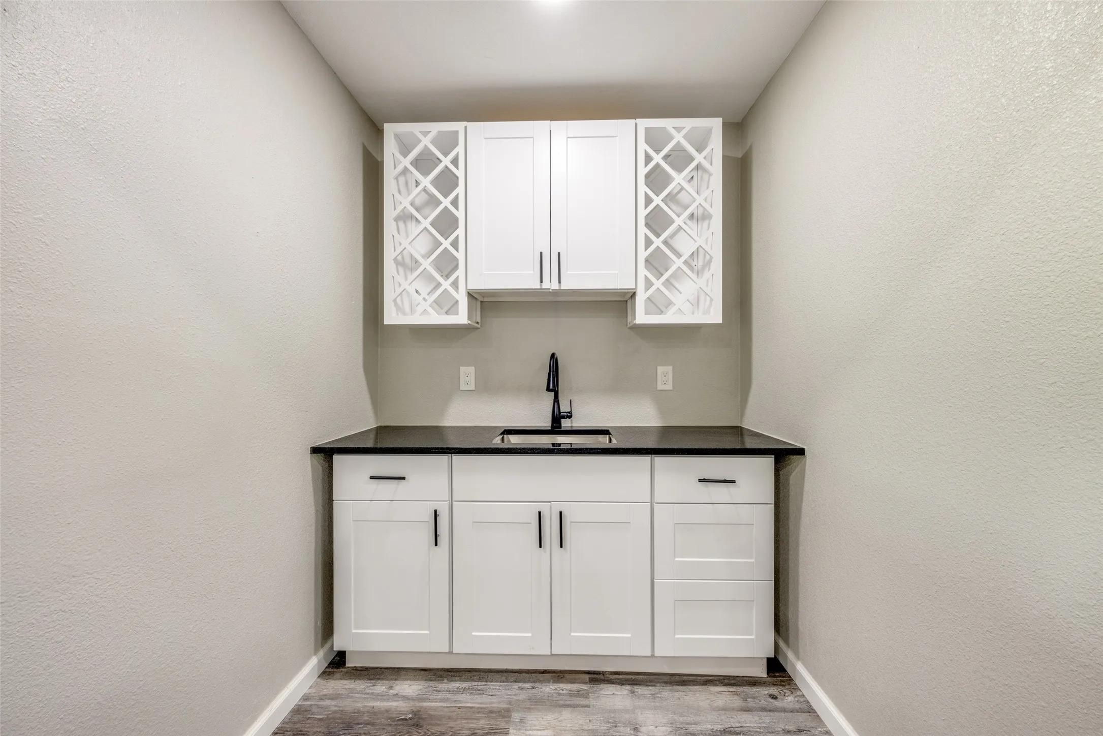 Indoor bar with wood finished floors and baseboards