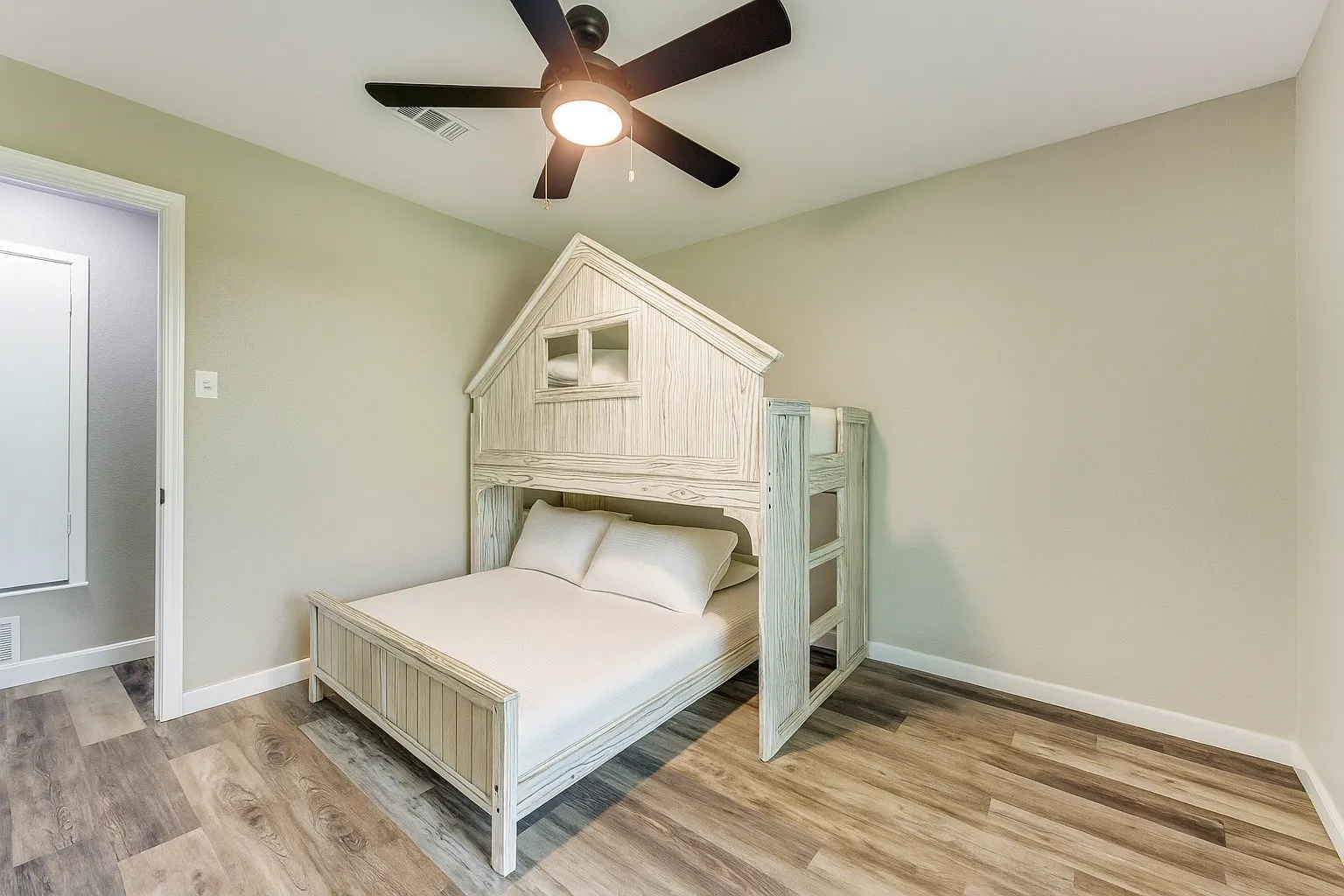 Bedroom featuring light wood-type flooring and a ceiling fan