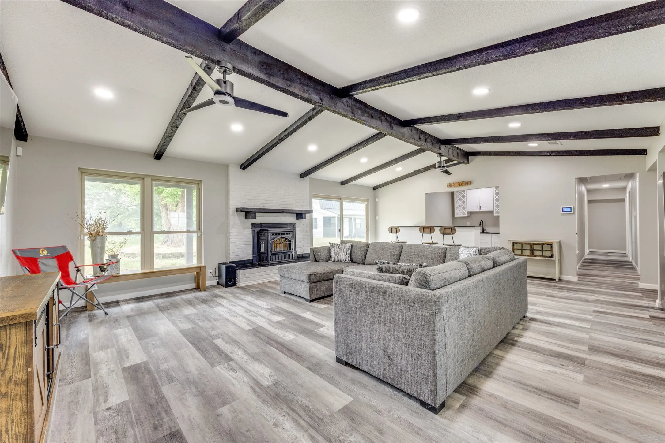 Living room featuring healthy amount of natural light, recessed lighting, light wood-style floors, and a fireplace