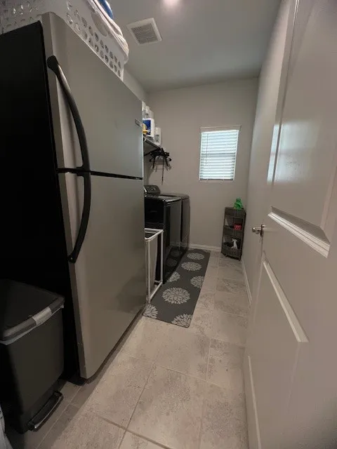 Extra space in laundry room for additional fridge with full size washer and dryer.