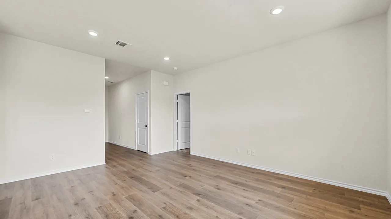 Expansive room featuring wood-finish flooring, recessed lighting, white walls, and white trim