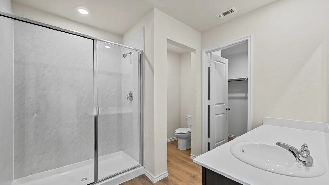 Glass-enclosed shower with a textured shower surround