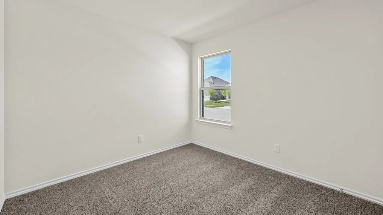 Neutral interior room featuring white walls, gray carpeting, white trim, and a double-pane window