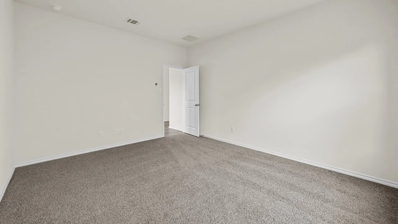 Neutral-toned room featuring light gray carpeting and white painted walls