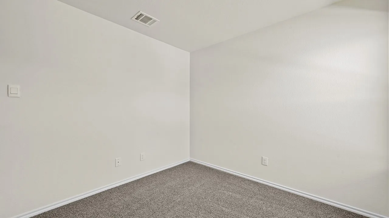 Neutral-toned walls complement the gray carpeting