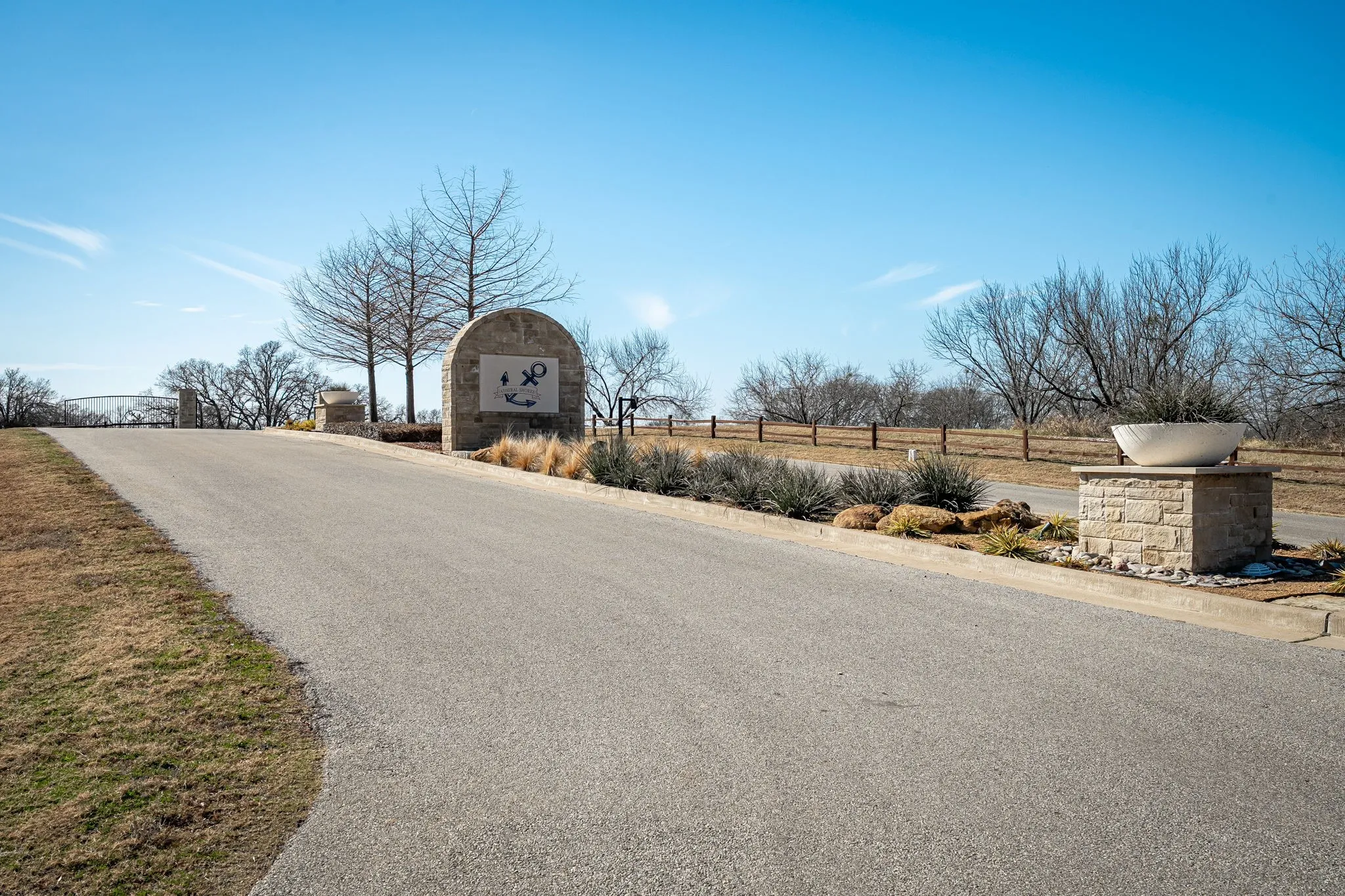 Community Entrance – A paved private road leads to the gated entrance of Admiral Shores, offering a welcoming arrival and added privacy.