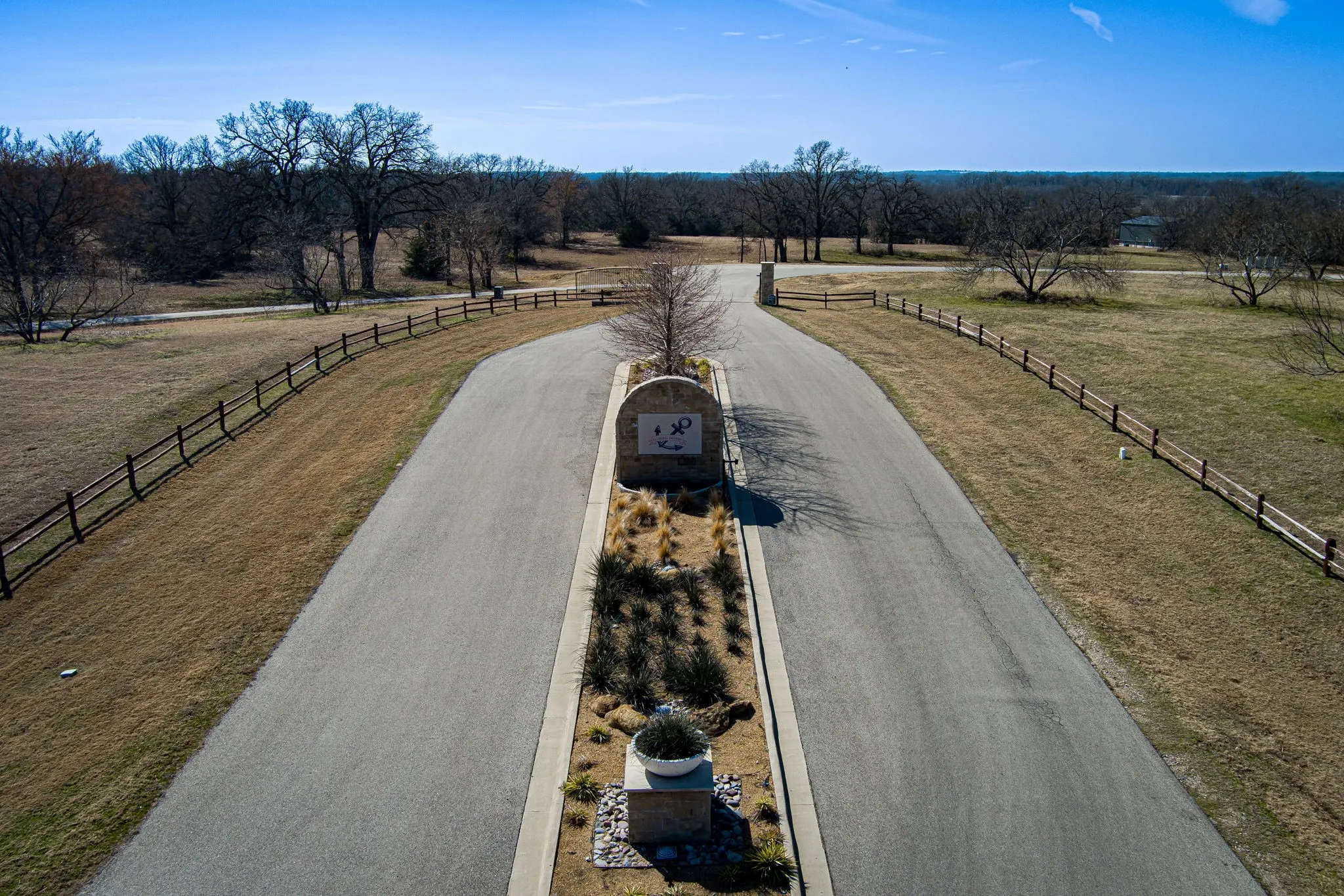 Neighborhood Monument Sign – Stone monument signage marks the entry into Admiral Shores, a lakeside community with private marina and park access.Split Entry Drive – A beautifully landscaped center median guides residents through the dual-lane entry into this secure, scenic development.