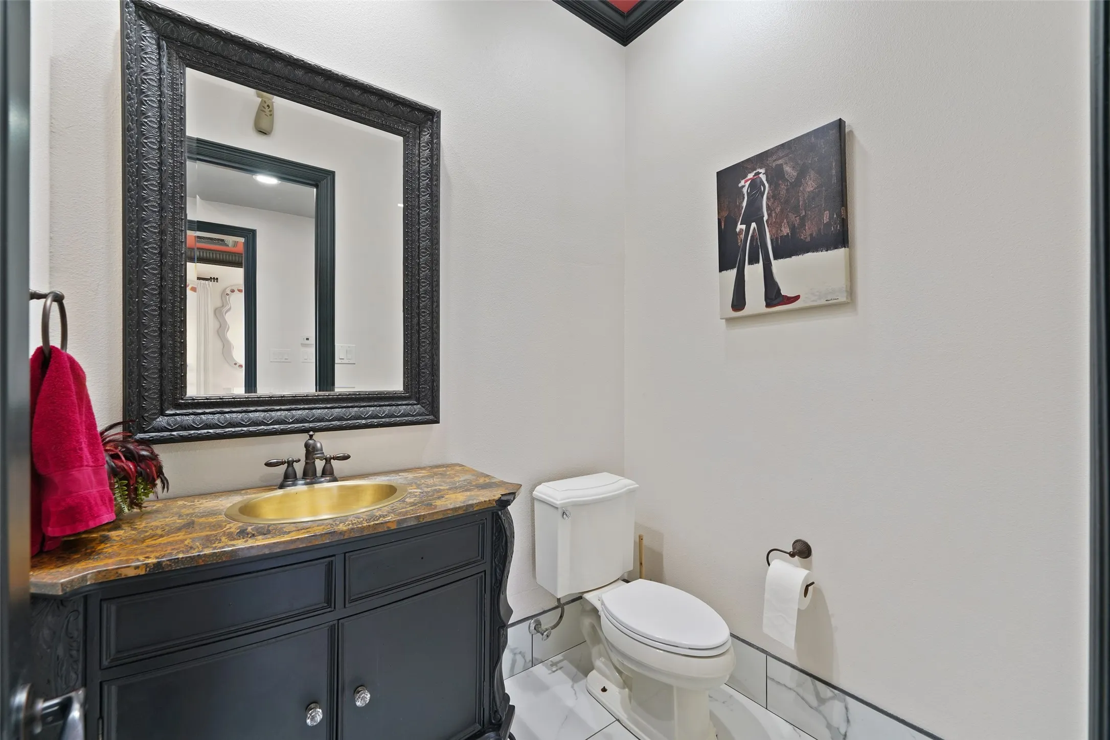 Half bath featuring toilet and vanity