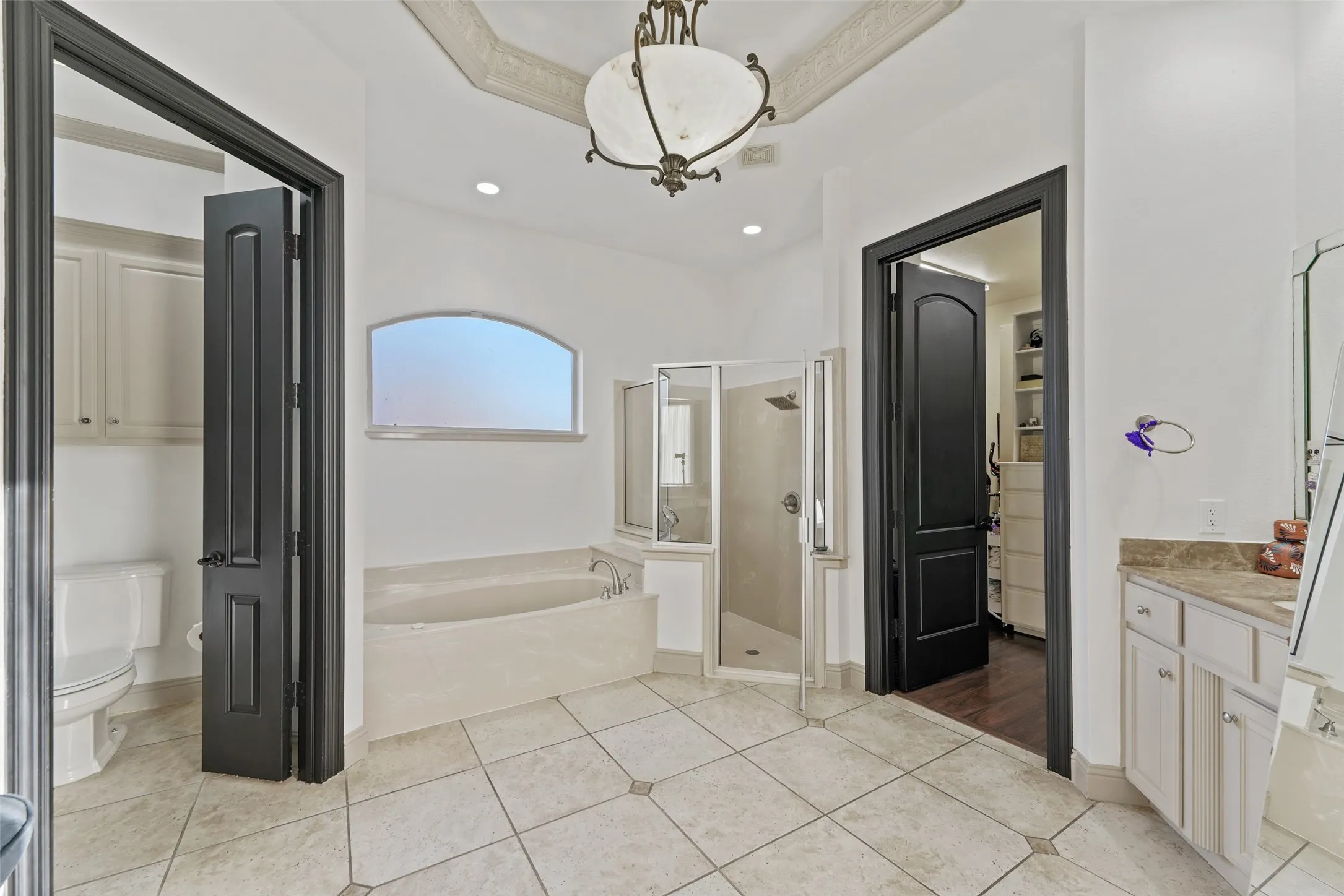 Bathroom with a shower stall, a bath, vanity, light tile patterned flooring, and recessed lighting