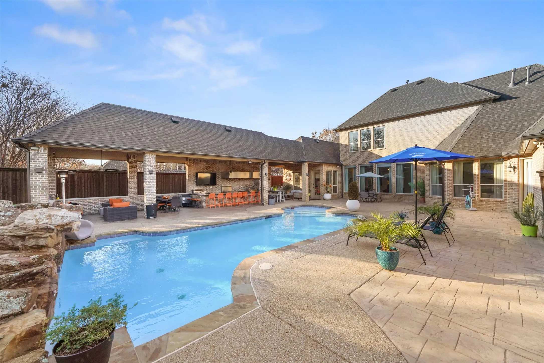 View of swimming pool featuring patio surround, a fenced backyard, and outdoor seating