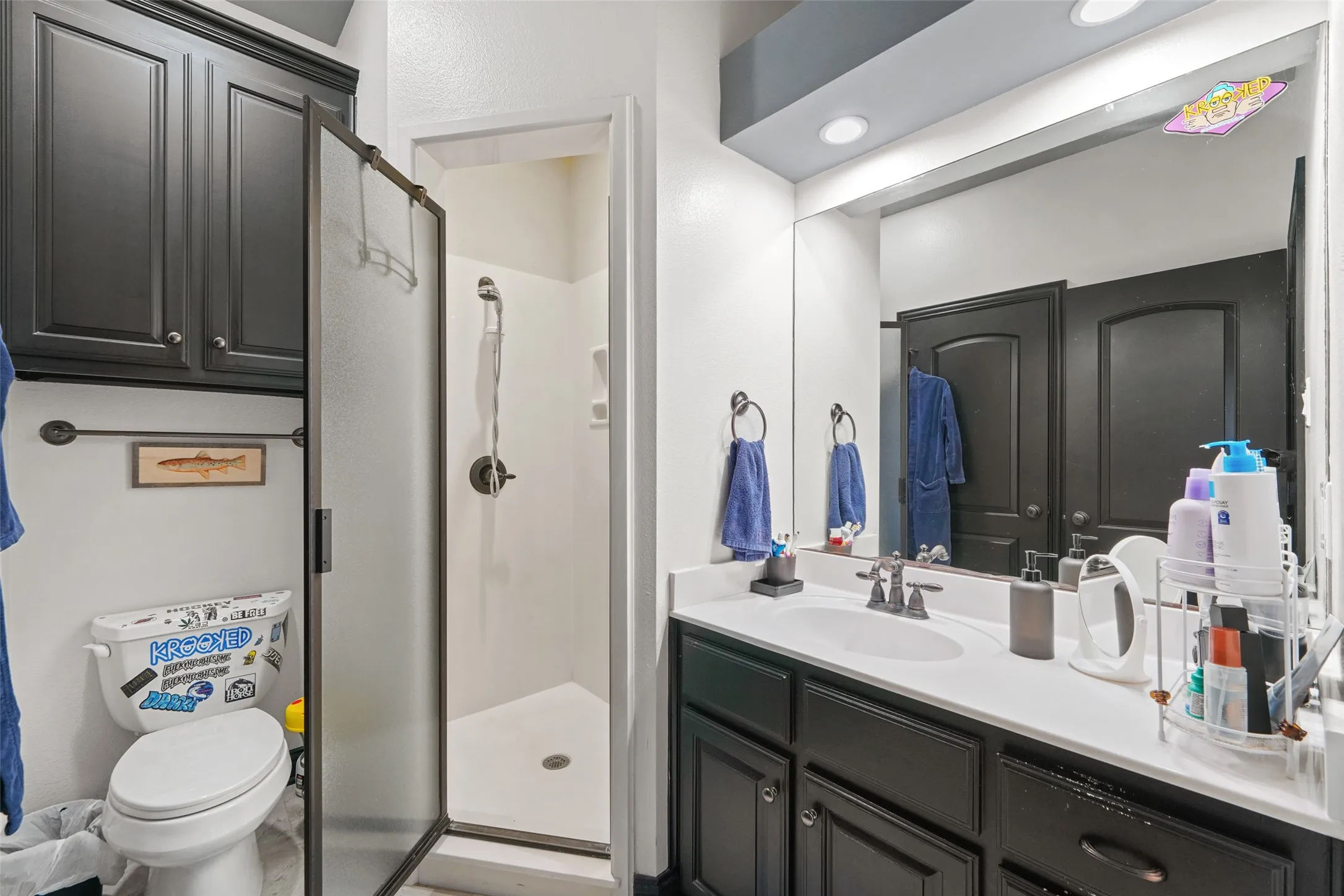 Full bathroom featuring a stall shower and vanity